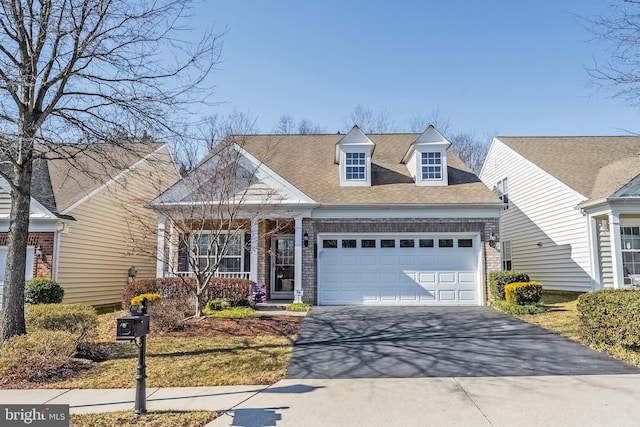 view of front of house featuring aphalt driveway, an attached garage, brick siding, and a shingled roof