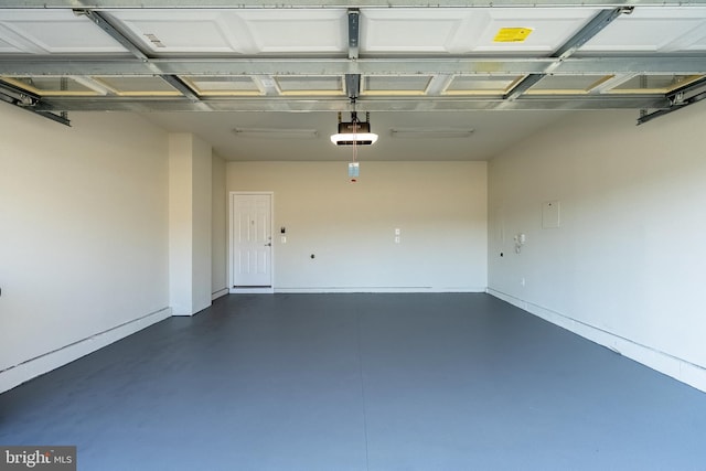 garage with baseboards and a garage door opener