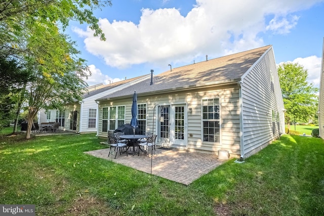 rear view of property featuring a patio and a lawn