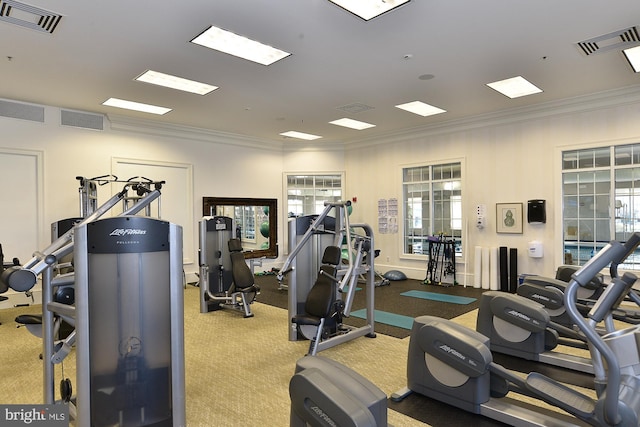 exercise room featuring visible vents and crown molding