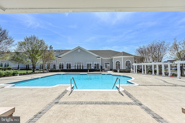 pool with a patio, fence, and a pergola