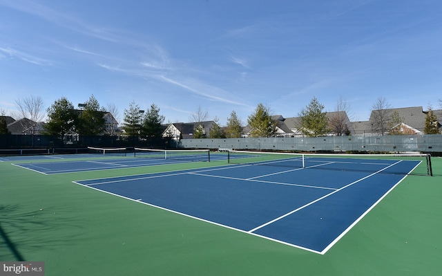 view of tennis court with fence