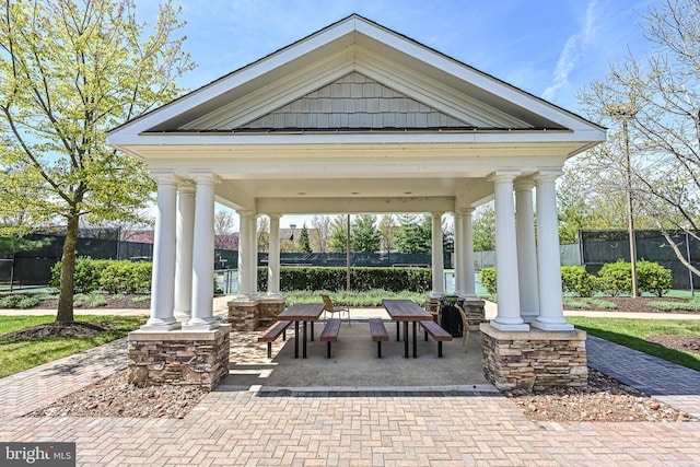 view of home's community with fence and a gazebo