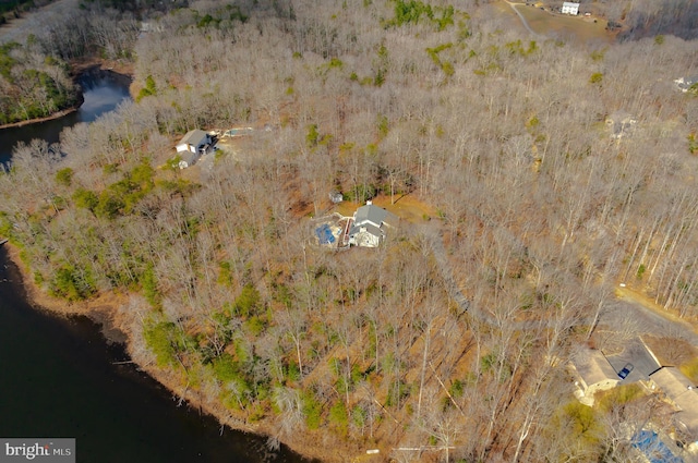 drone / aerial view with a water view and a wooded view