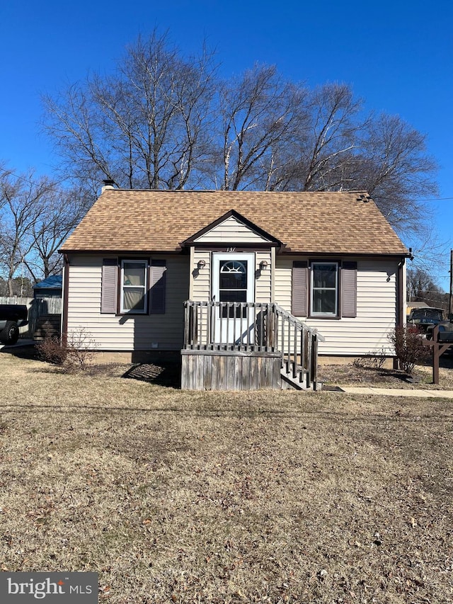 bungalow-style home featuring roof with shingles