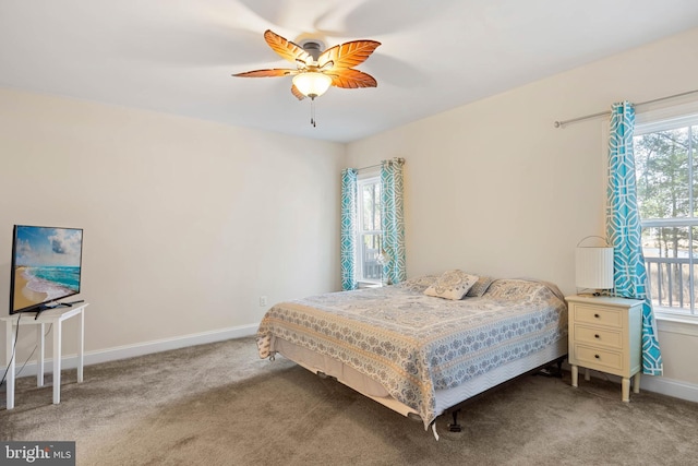 carpeted bedroom featuring a ceiling fan and baseboards