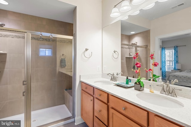 full bathroom with a sink, visible vents, double vanity, and ensuite bathroom