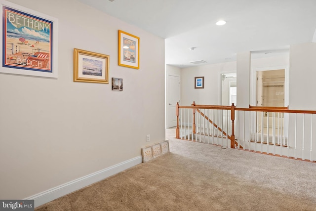 hallway featuring recessed lighting, baseboards, an upstairs landing, and carpet floors