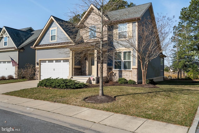 view of front facade with a front yard, driveway, a shingled roof, stone siding, and a garage