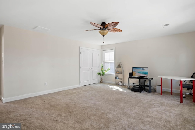 interior space featuring baseboards, carpet, visible vents, and ceiling fan