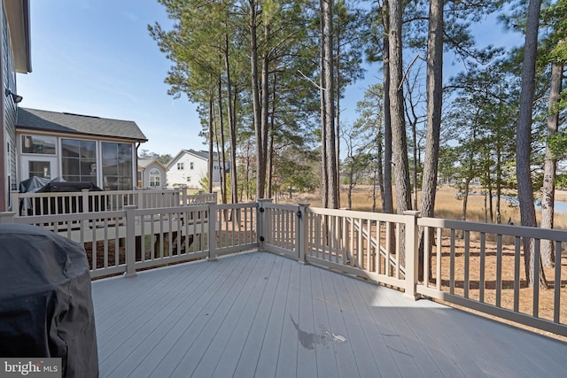 wooden deck with grilling area, a residential view, and a sunroom