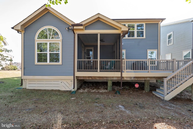 rear view of house with ceiling fan and a sunroom