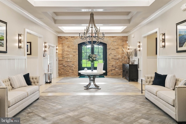 interior space featuring an inviting chandelier, a skylight, crown molding, and wainscoting