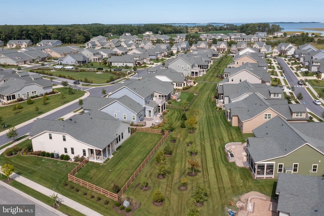 drone / aerial view featuring a residential view and a water view