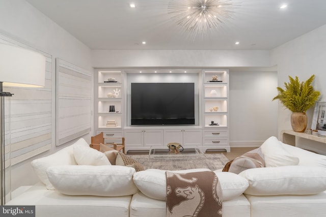 living room featuring baseboards, built in features, an inviting chandelier, light wood-style floors, and recessed lighting