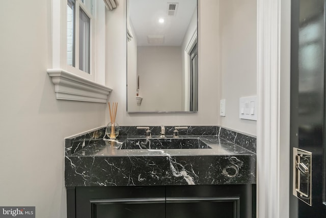 bathroom featuring vanity and visible vents