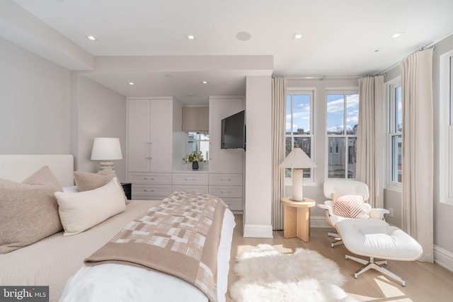 bedroom with recessed lighting, baseboards, and light wood finished floors