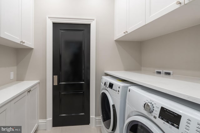 washroom with separate washer and dryer and cabinet space