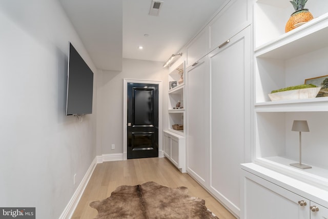 doorway with light wood-type flooring, visible vents, baseboards, and recessed lighting