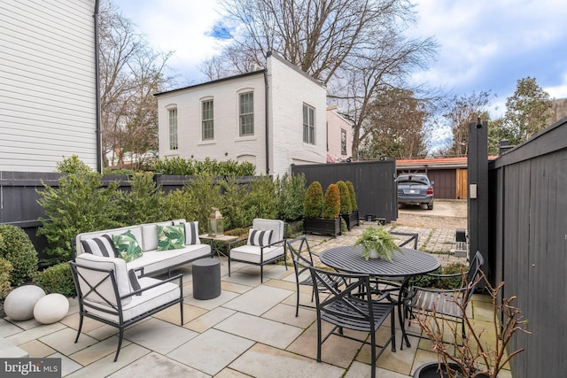 view of patio / terrace featuring an outdoor hangout area and fence