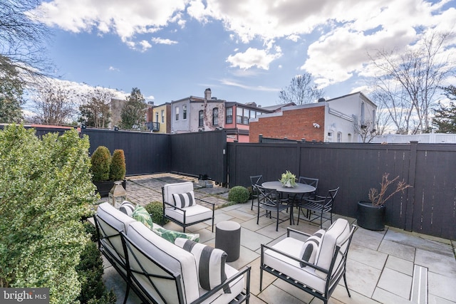 view of patio / terrace with a fenced backyard, an outdoor hangout area, and outdoor dining area