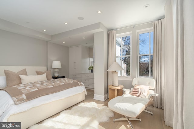 bedroom with light wood-style flooring, baseboards, and recessed lighting