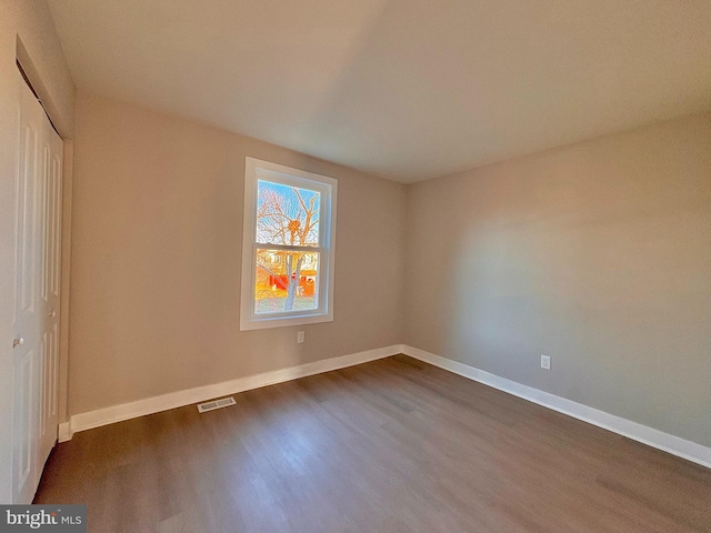 unfurnished bedroom with a closet, visible vents, light wood-style flooring, and baseboards