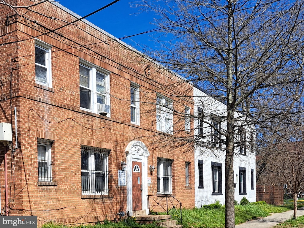 view of property with brick siding