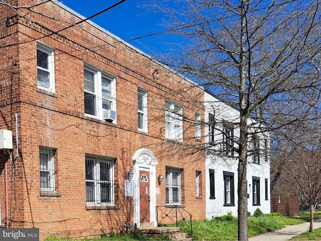 view of property with brick siding