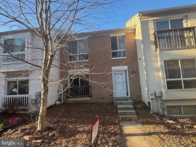 townhome / multi-family property with entry steps and brick siding