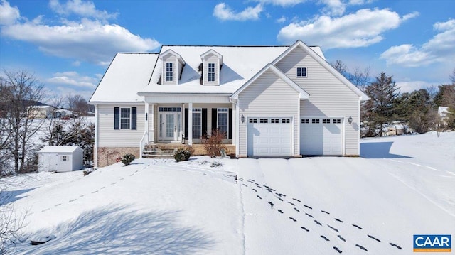 cape cod house featuring an attached garage and a storage unit