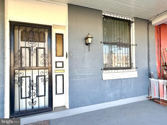 doorway to property with brick siding