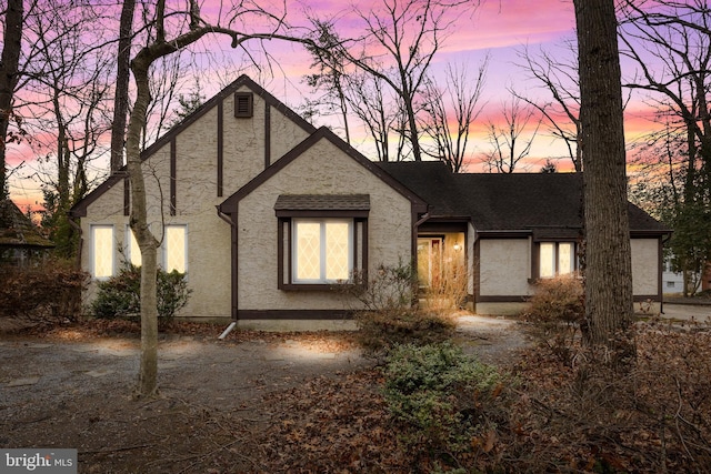 english style home featuring stucco siding