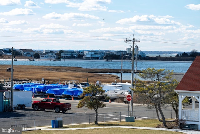 view of vehicle parking featuring fence