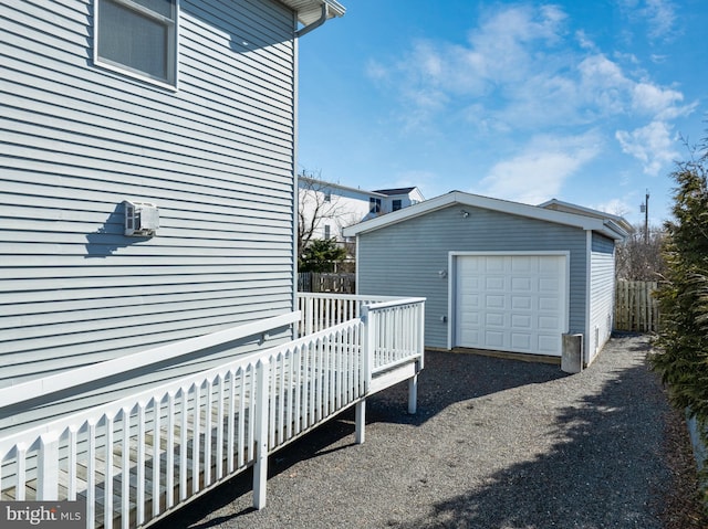 detached garage with driveway and fence