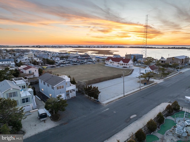 aerial view at dusk with a water view