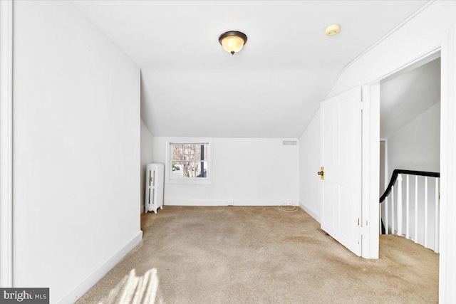 bonus room featuring carpet, baseboards, vaulted ceiling, and radiator heating unit