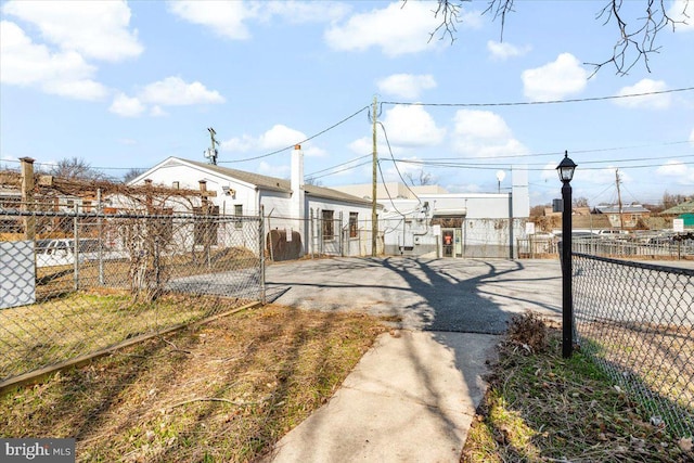 view of street with driveway and a gated entry