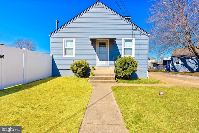 bungalow with a front yard and fence