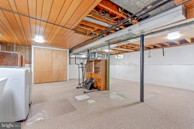 unfinished basement with wood ceiling, washer / clothes dryer, and carpet floors