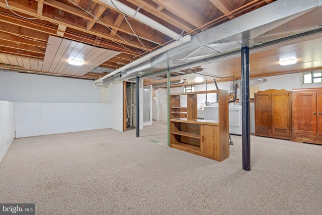 below grade area featuring washer / clothes dryer and carpet floors