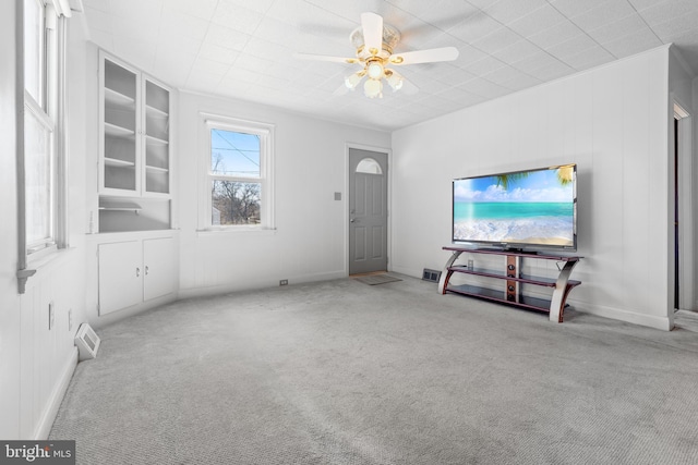 unfurnished living room with carpet flooring, a ceiling fan, and visible vents