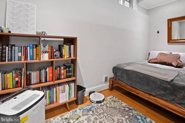 bedroom with wood finished floors and baseboards