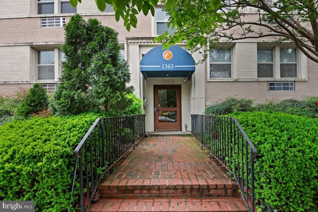 view of exterior entry with brick siding