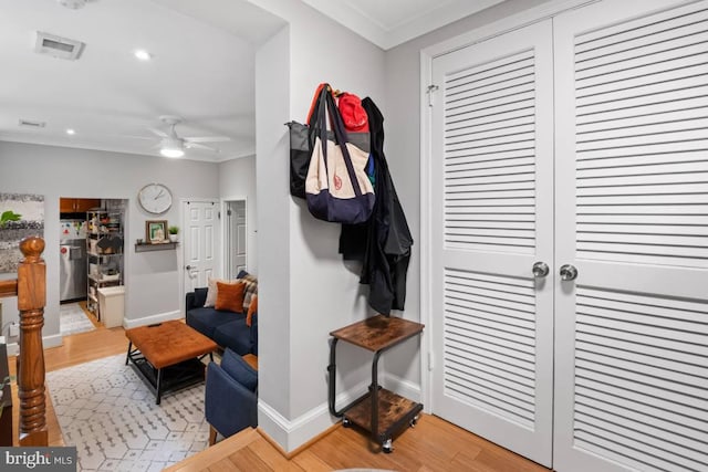 mudroom featuring crown molding, recessed lighting, visible vents, light wood-style flooring, and baseboards