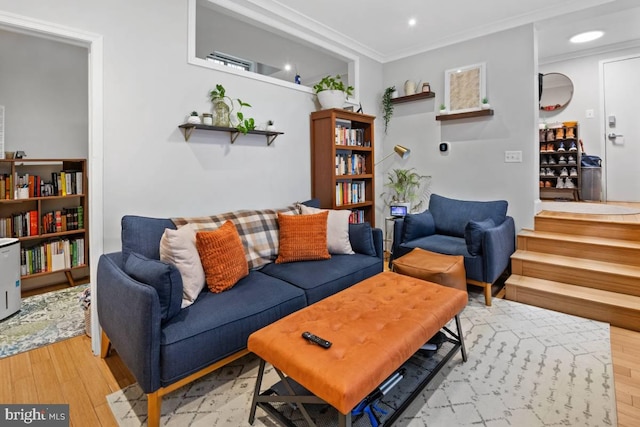 living room with ornamental molding, light wood-style flooring, and recessed lighting