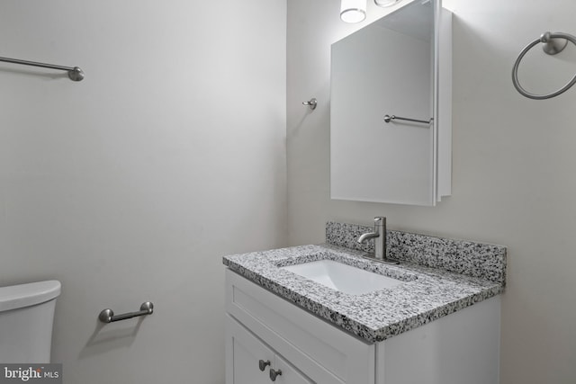 bathroom featuring toilet and vanity