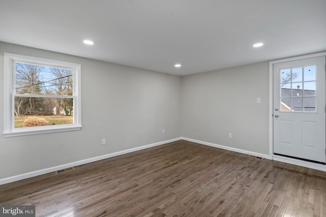 entryway featuring a wealth of natural light, visible vents, dark wood finished floors, and baseboards