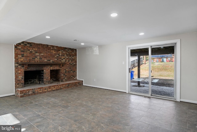 unfurnished living room with recessed lighting, a fireplace, and baseboards