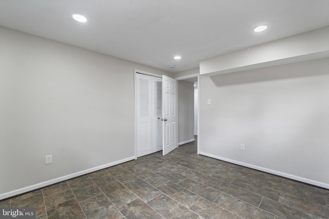 interior space featuring stone finish floor, recessed lighting, and baseboards